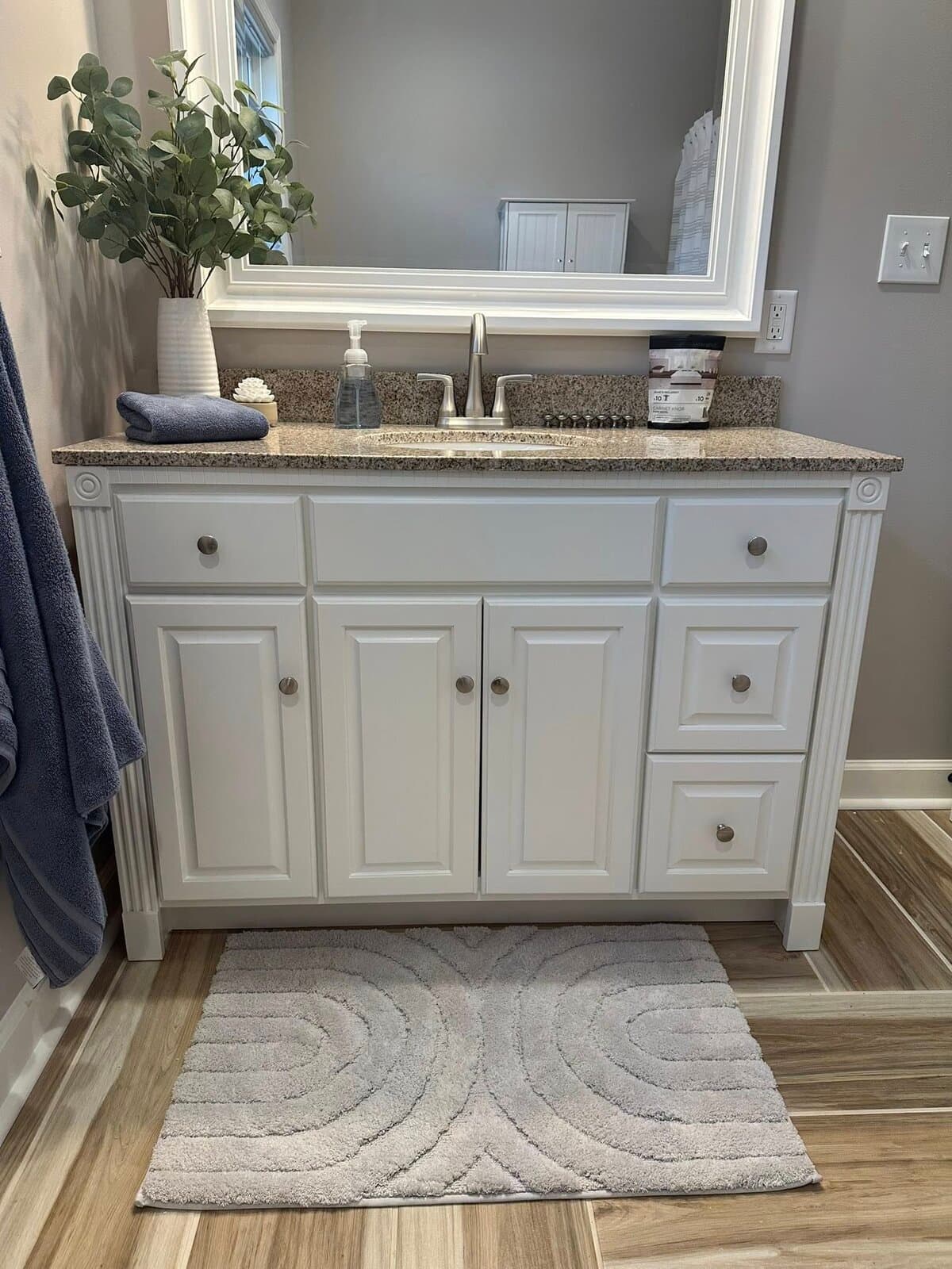 Refinished white bathroom vanity with granite top